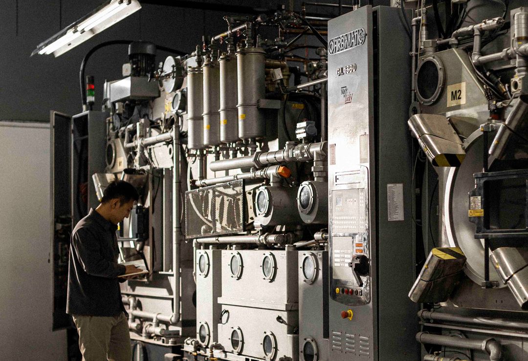 An engineer checking a commercial dry cleaning machine at Washing Dynasty